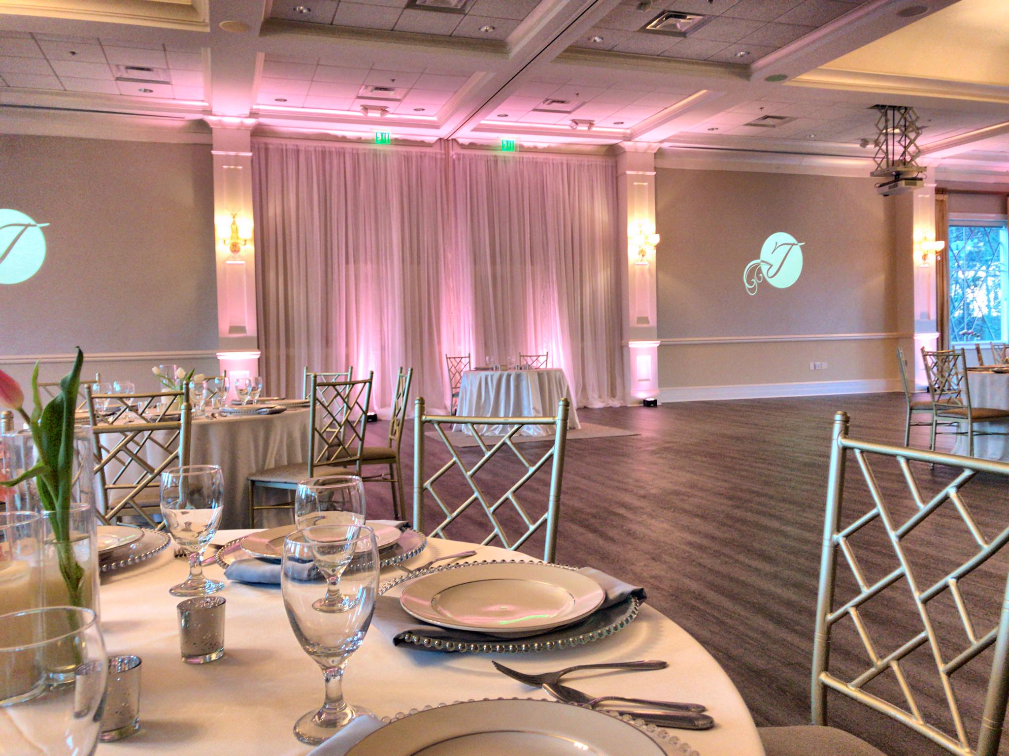 White pipe and drape with pink uplights Wilmington Uplighting event lights